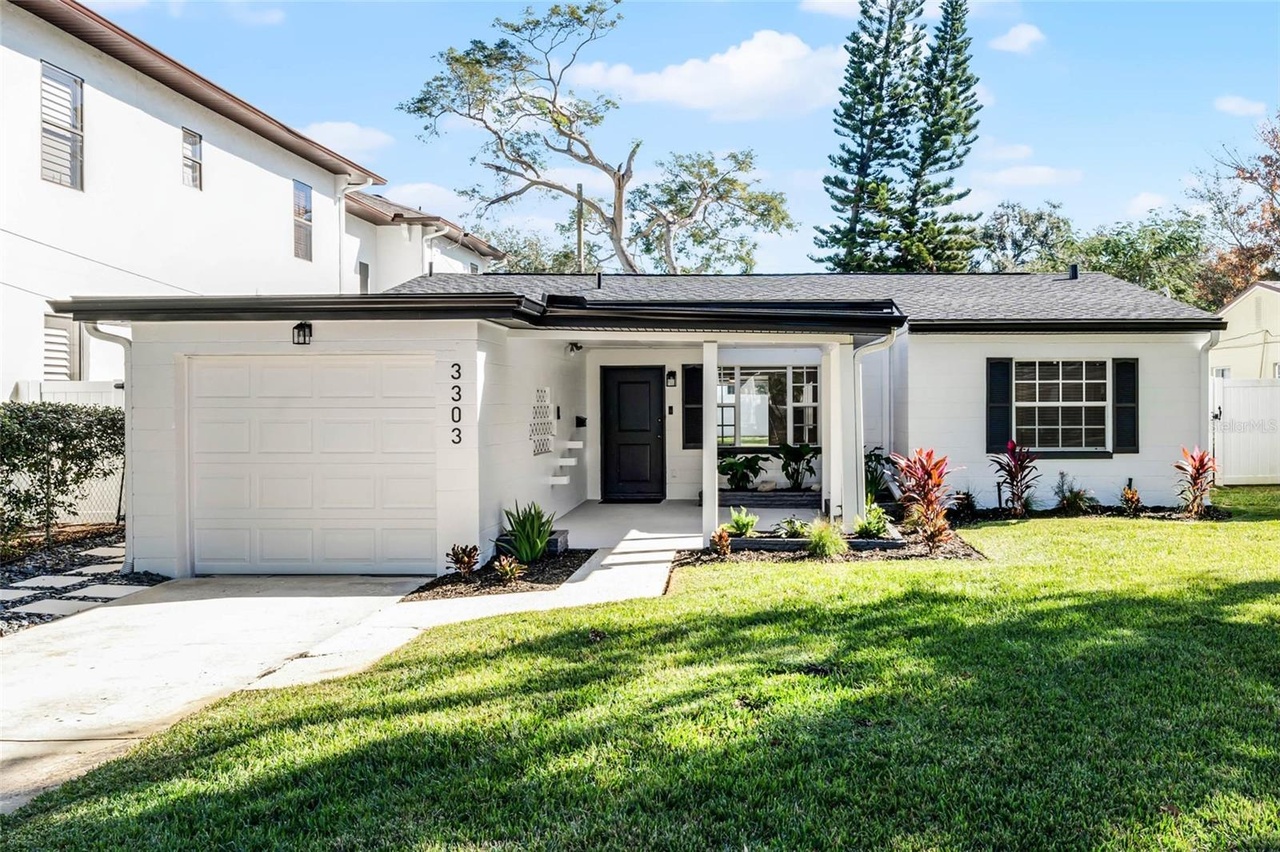 Renovated white home with a green lawn in Orlando